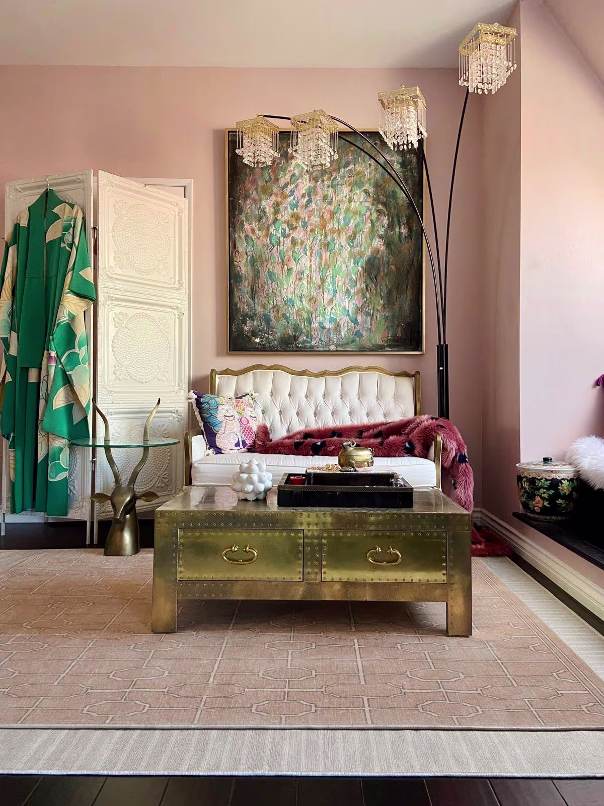 Image of a bedroom seating area with two colors of rugs (ivory and rose) layered on top of each other: Ruggable x The Hiltons Bel Air Ivory Rug and the Ruggable x The Hiltons Diana Trellis Rose Gold.
