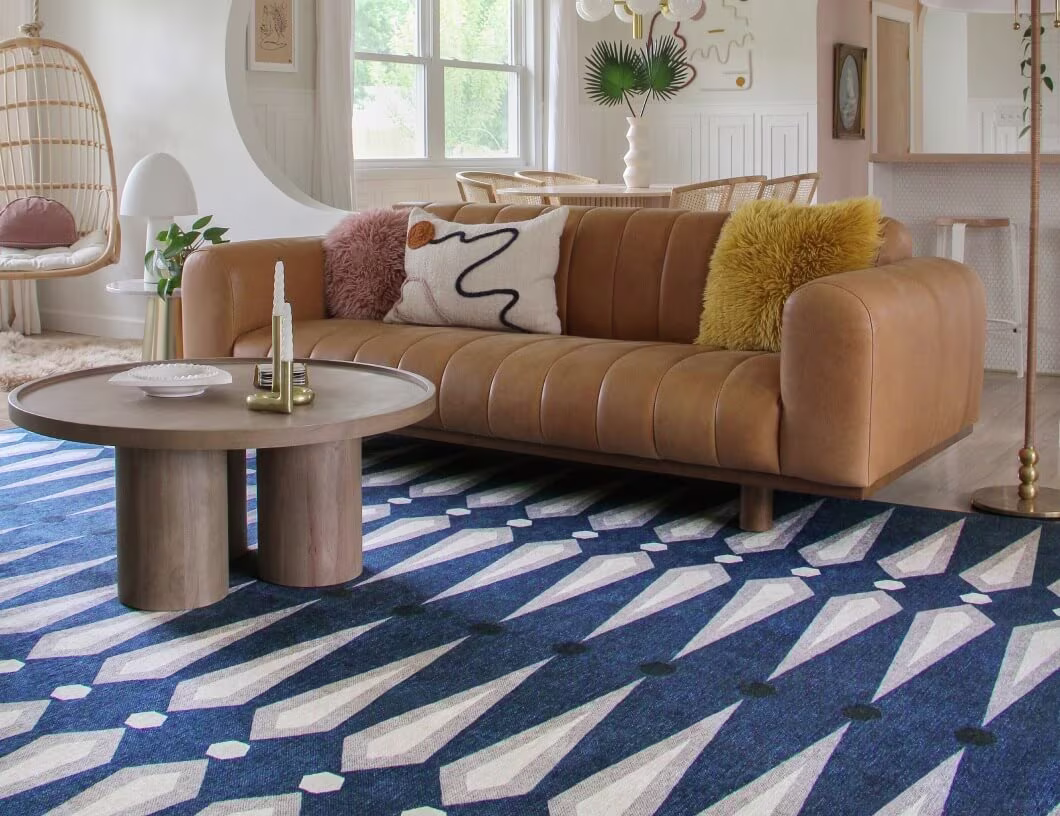 Ruggable's Jonathan Adler Carnaby Admiral Blue in a living room, placed beneath a couch