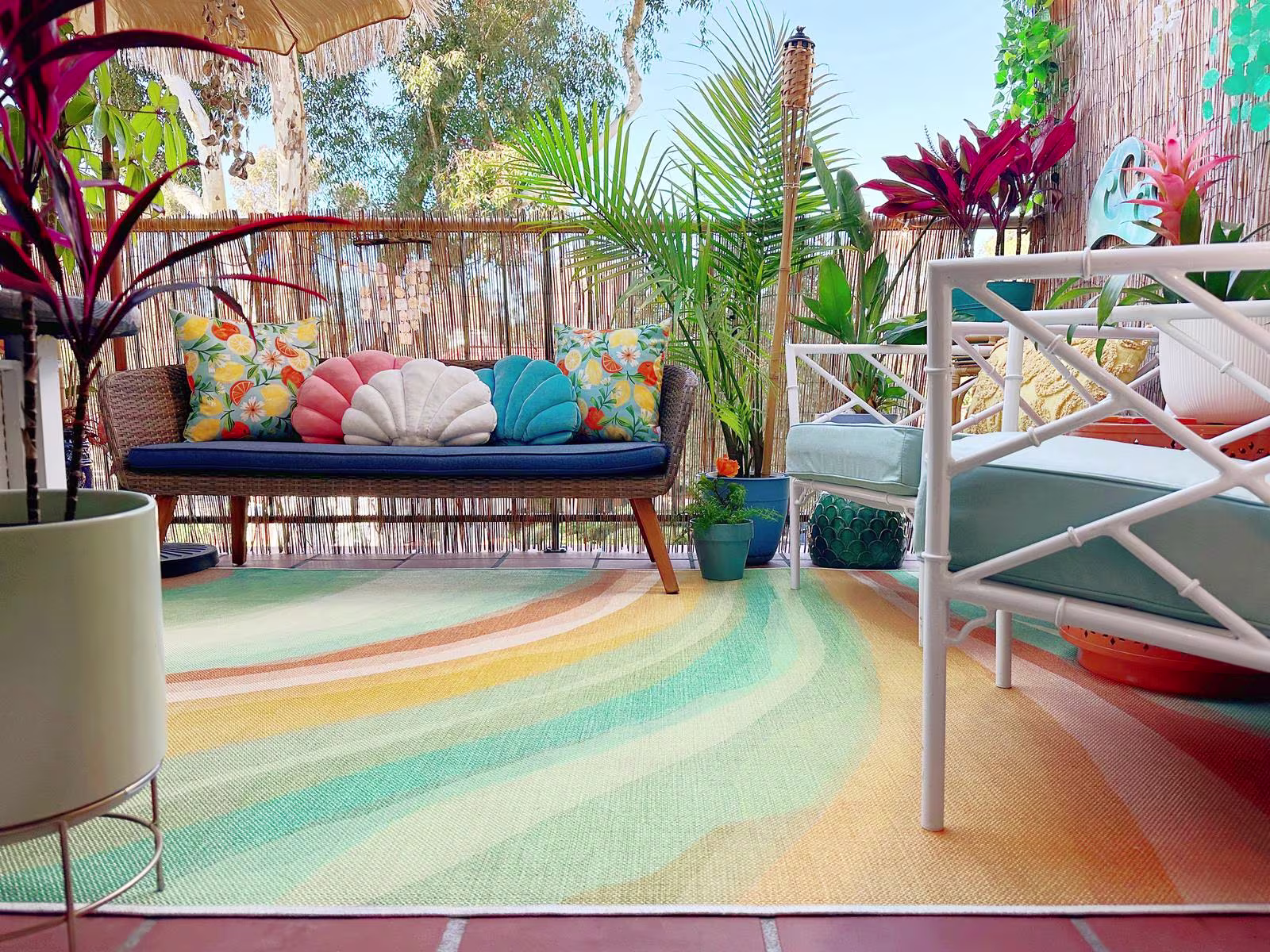 Tropical patio in summer featuring Ruggable Outdoor Watercolor Waves Copper Jade Rug