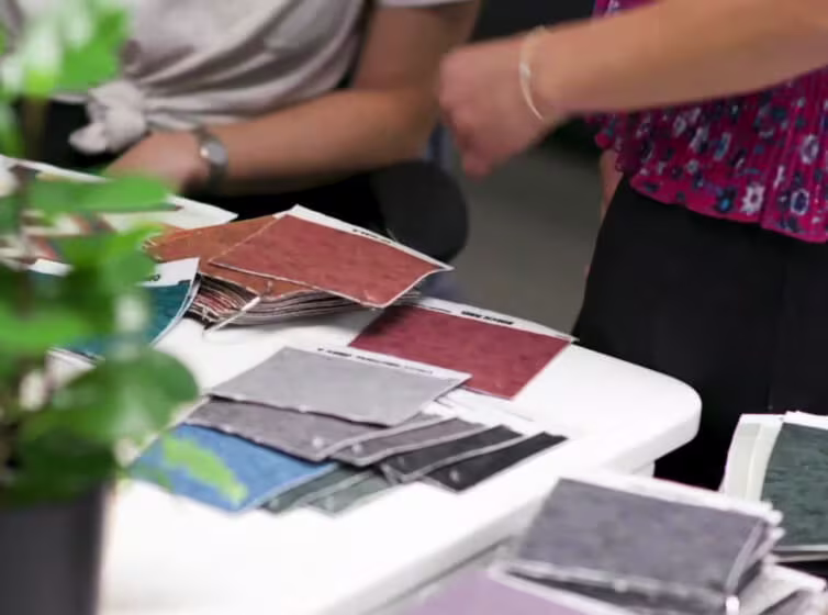 Ruggable Designers sitting next to swatches of colors in design studio | Ruggable
