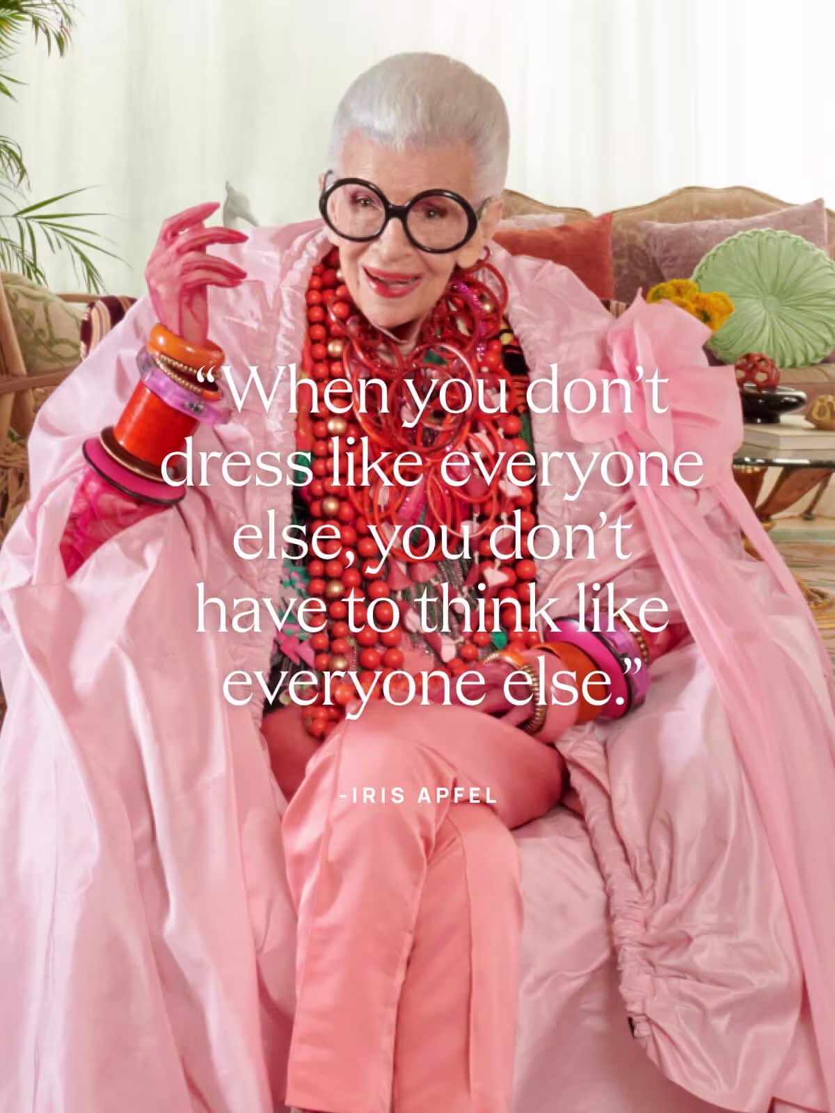 Image of Iris Apfel wearing a pink and red outfit with text overlay "When you don't dress like everyone else, you don't have to think like everyone else."