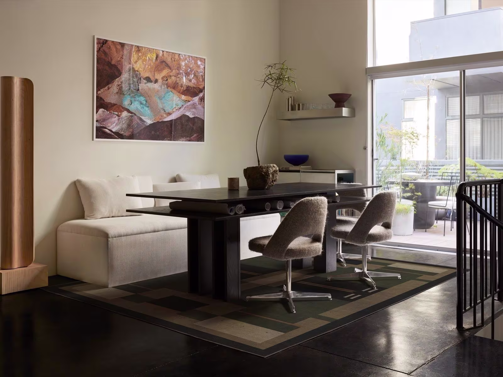 Image of a loft-style living room and work space with exposed ceilings and the Ruggable x Architectural Digest Monolith Olive Green Rug. 