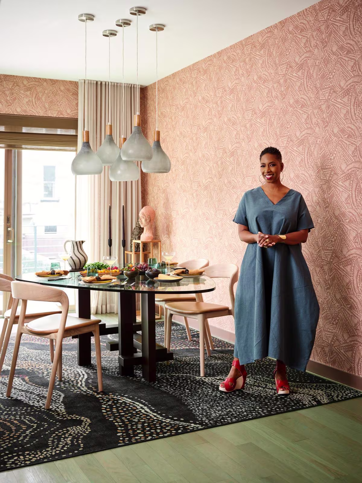Malene Barnett stands in her dining room atop her washable Ruggable x Malene Barnett Adorned Black Multicolor Rug