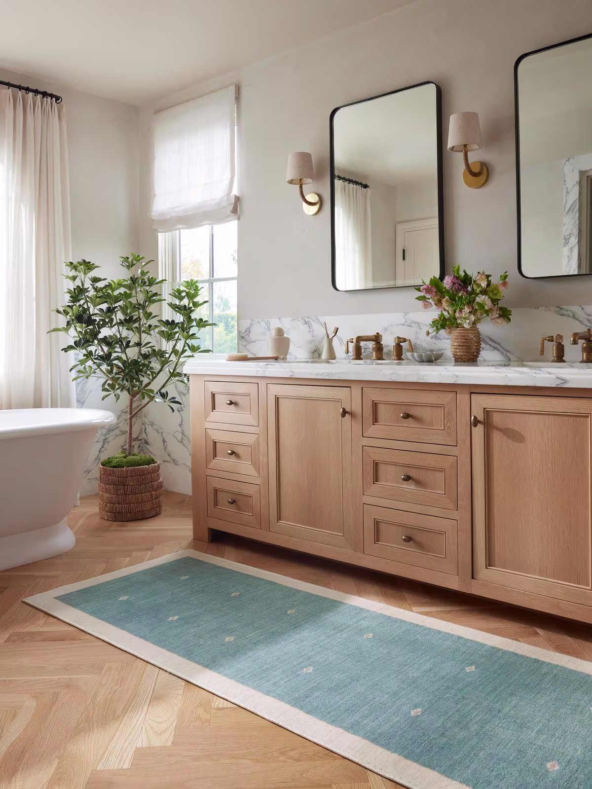 Ruggable x goop Luna Soft Teal Rug in marble and white oak bathroom