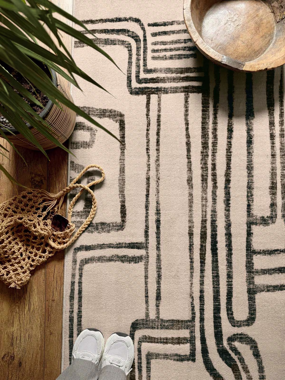 Ruggable x Malene Barnett Kassena Black & Ivory rug with potted house plant and hand carved bowl