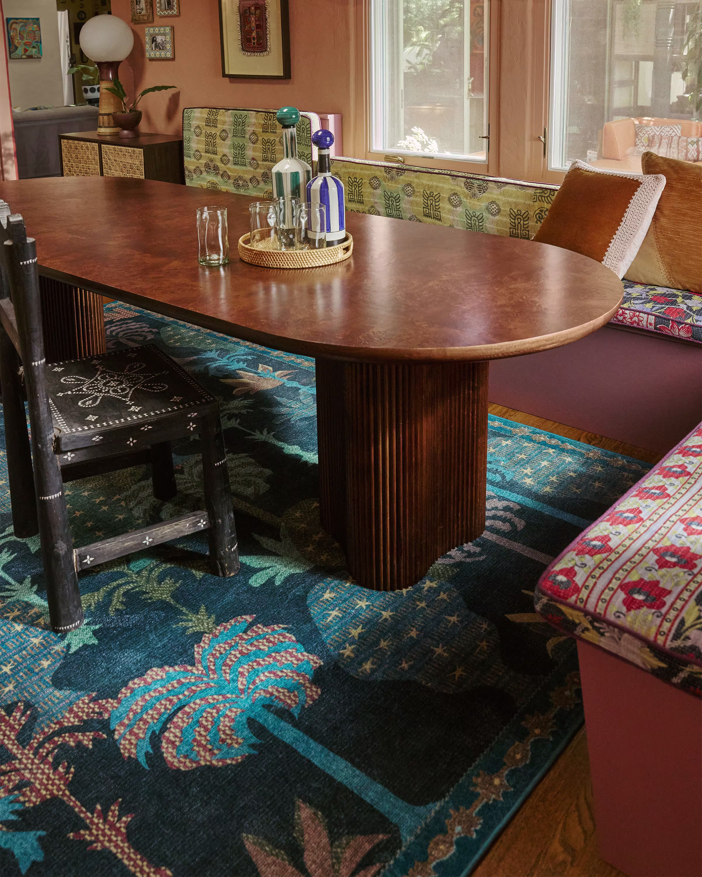 Ruggable x Jungalow Palmistry Midnight blue tufted area rug with a palm tree pattern in a bohemian dining room.
