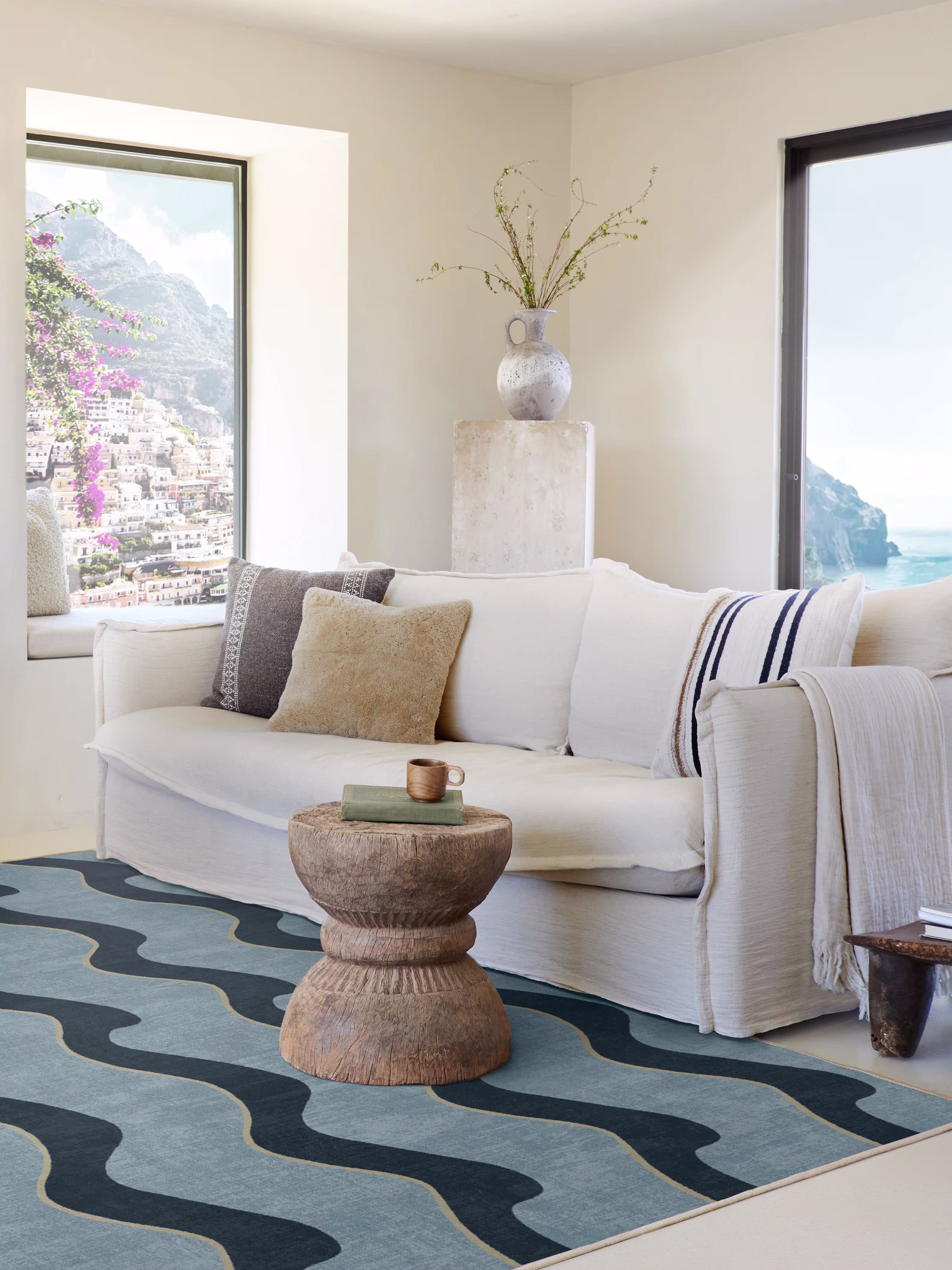 Mediterranean coastal living room with rustic furniture, plaster walls, window seats, white couch and Onda Slate Blue Rug 