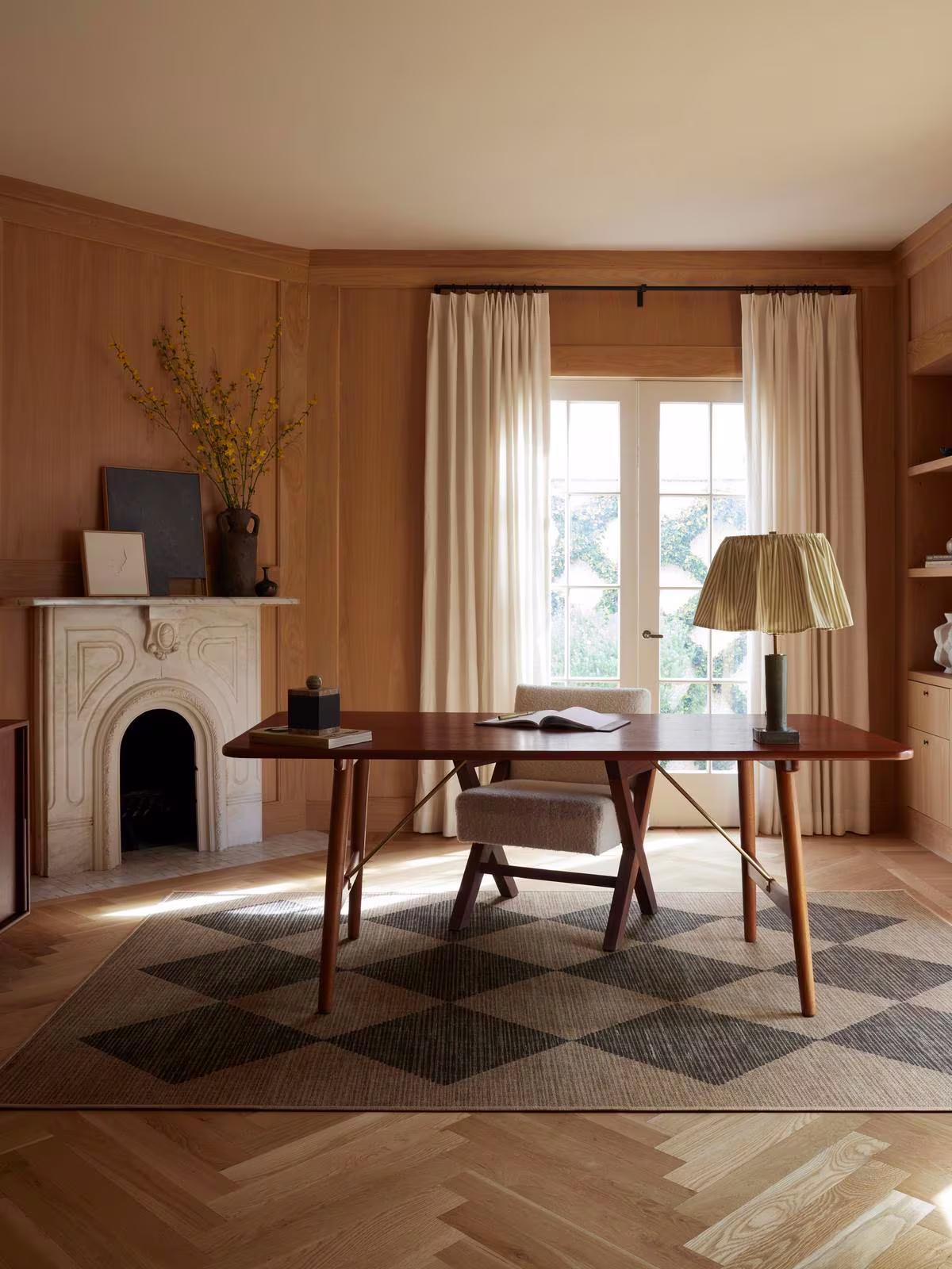 Ruggable x goop Salerno Soft Black Re-Jute Rug in home office with fireplace and organic modern decor