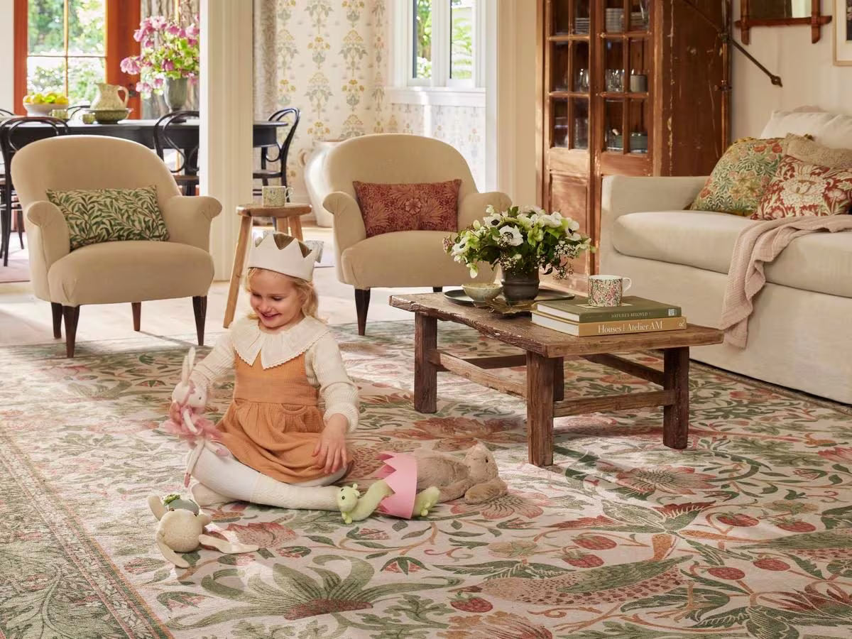 Child plays make believe on a washable Ruggable x Morris & Co. rug in her living room