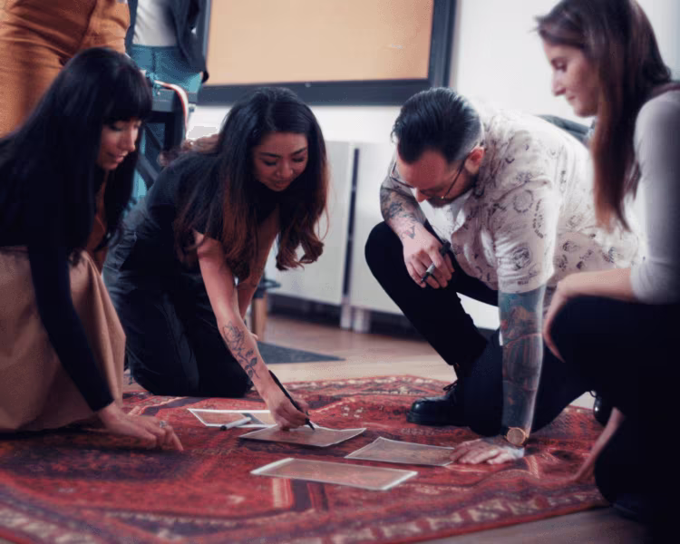 Ruggable designers working on designs on Kaden Amber Red Rug Mobile | Ruggable