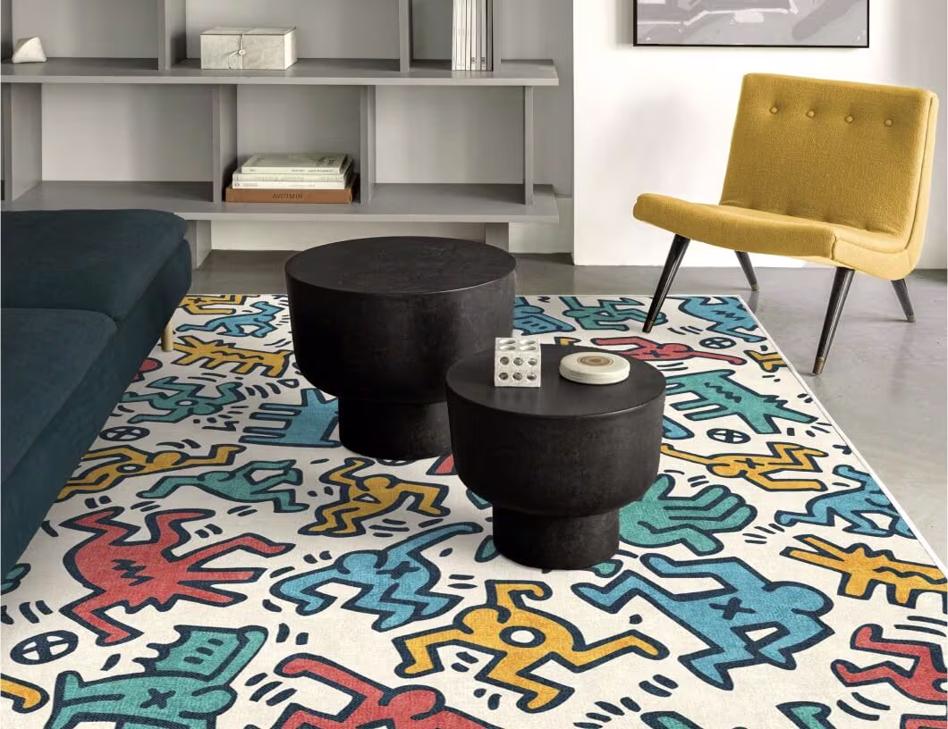 Keith Haring Block Party Multicolor Rug featuring vivid yellow, turquoise, red, and navy blue figures on an ivory background.