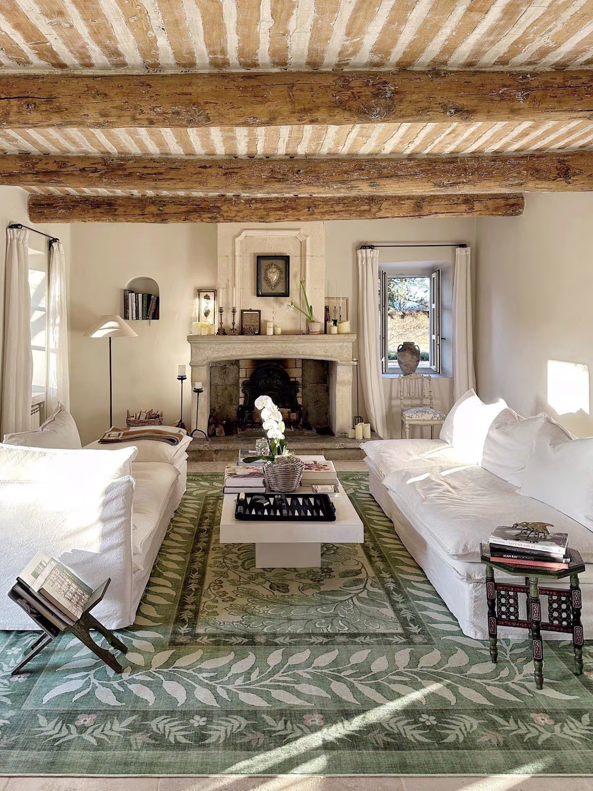 A rustic French living room with a white couch, wooden furniture, and the Provence Sage with washable Ruggable Provence Sage Rug