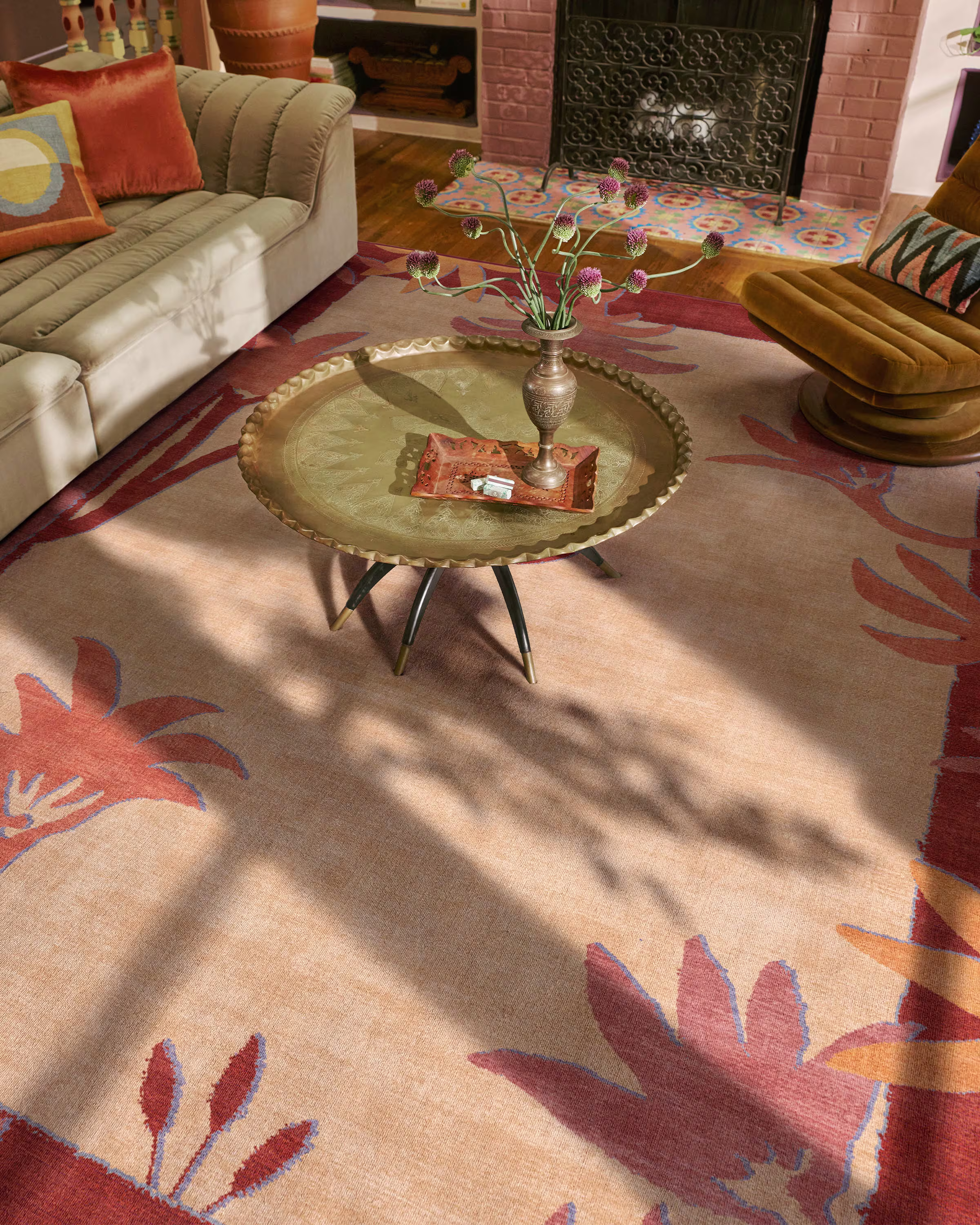 Ruggable x Jungalow Palmistry Pinstripe warm brown tufted rug in a bohemian style living room with a gold coffee table.