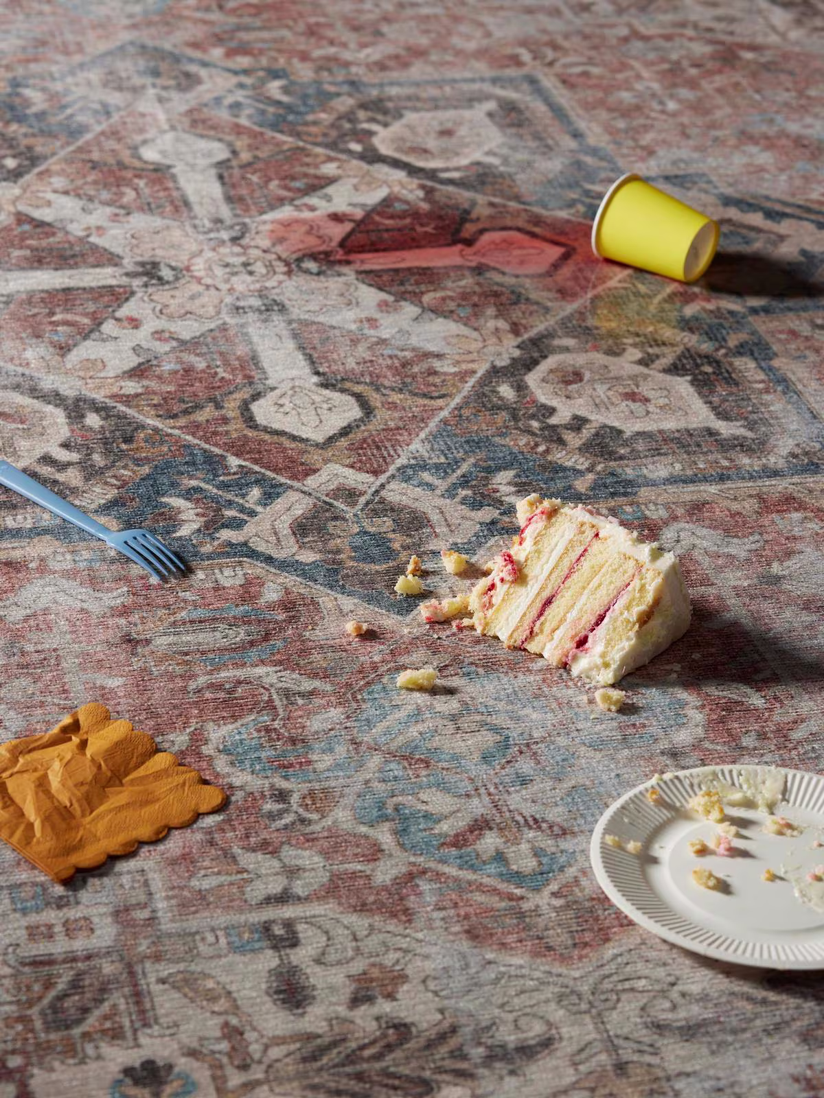 Image of Ruggable's Kamran Coral Tufted Rug with wine spills and cake crumbs.