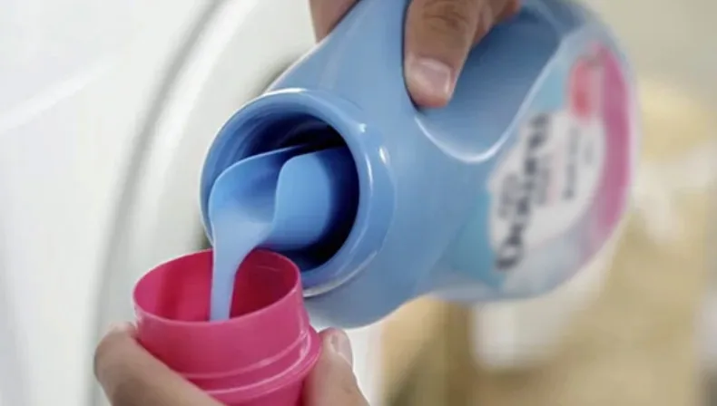 Measure the correct dose of Downy Fabric Conditioner.