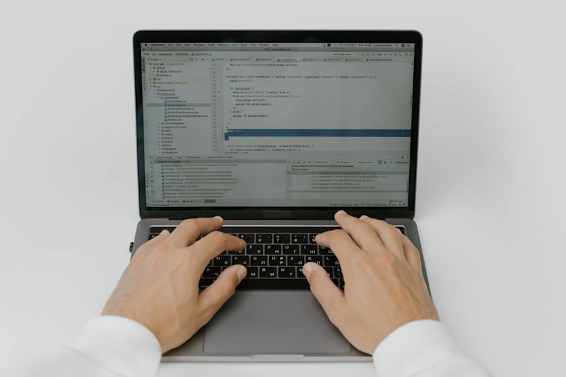 a person typing on a laptop with their hands