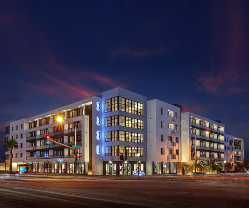 Modern multifamily development in Los Angeles with bold corner presence and ground-floor activation—designed for high-density urban living.