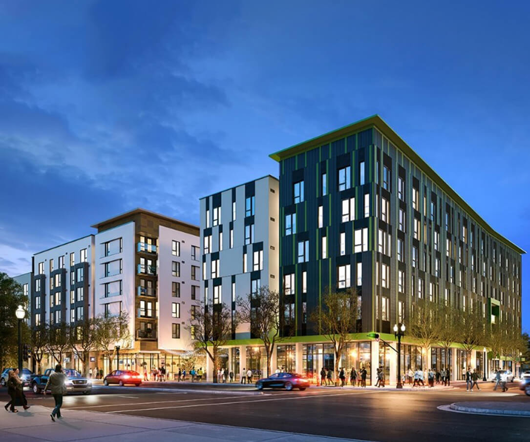 Stylish mixed-use multifamily apartment complex with green and white facade, street-level retail, and active pedestrian and vehicle traffic in the Bay Area.