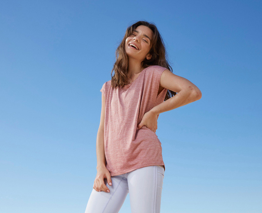 Woman smiling with a clear sky in the background