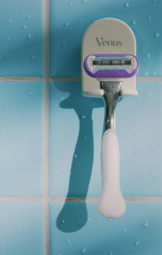 Razor on a razor rack attached to a bathroom wall