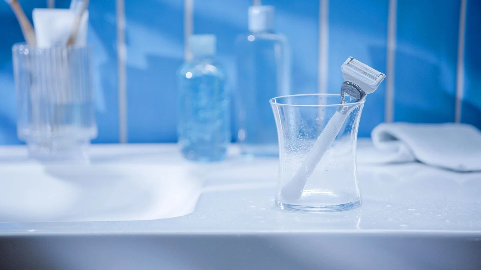 Razor in the glass on the bathroom sink