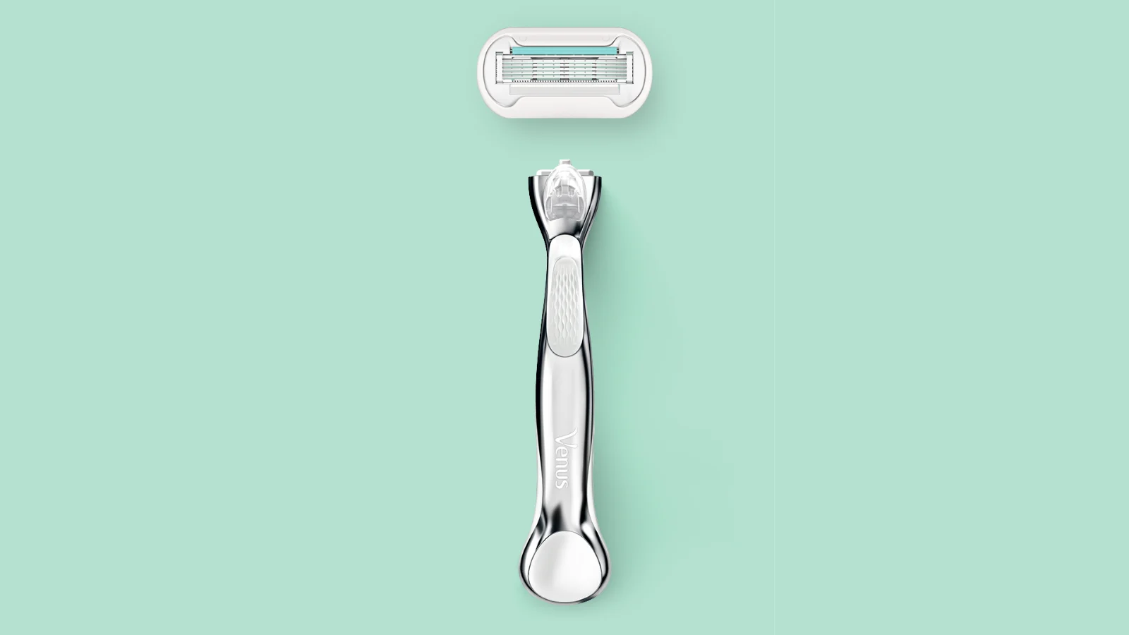 Silver razor with a detached oval razor head above it