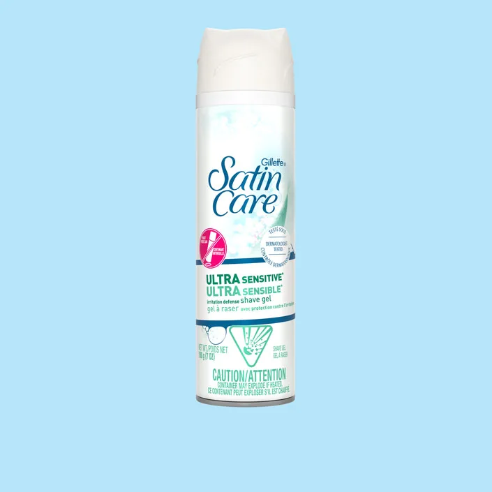 Gillette Venus Satin Care Ultra Sensitive shave gel can with white bottle on light blue background
