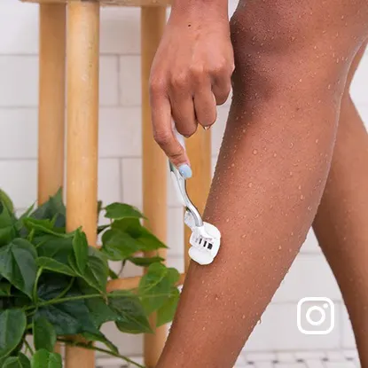 Woman shaving her leg with a Gillette Venus razor