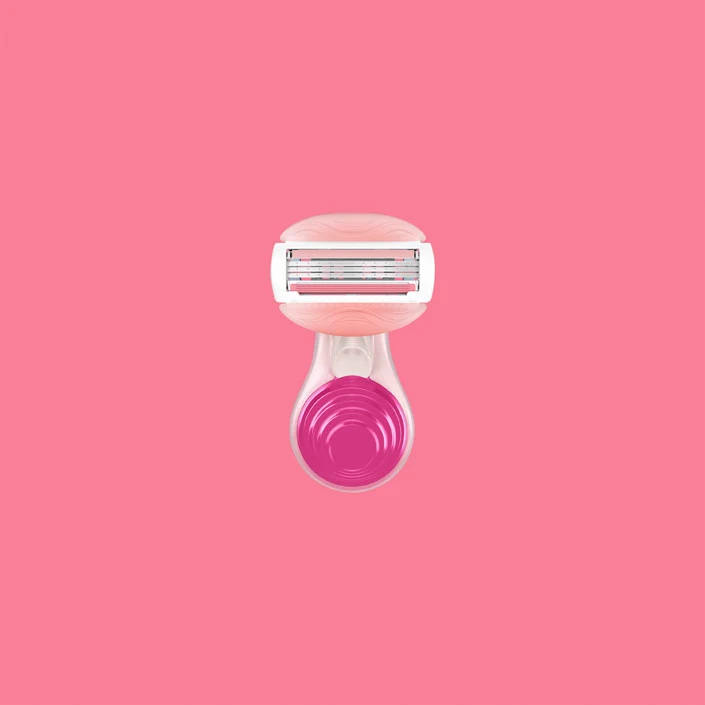 Gillette Venus ComfortGlide White Tea Mini razor head with gel bars and five blades on pink background