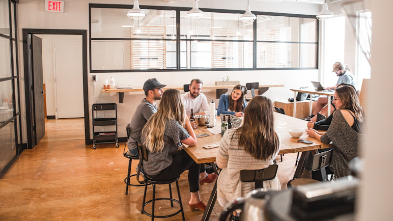 Employees enjoy lunch together in the break room.