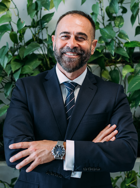 Business man smiling at camera with arms folded confidently