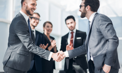 Advisors shake hands after reaching an agreement to buy an advisory practice