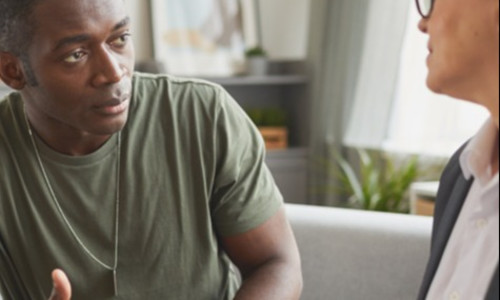 a Black veteran discusses his situation with a financial advisor