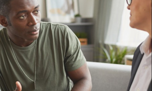 a Black veteran discusses his situation with a financial advisor