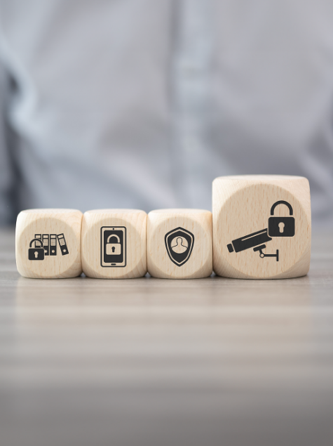 Four cubes on a table depict information security icons