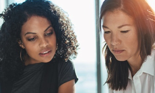 two women review financing options for their advisory business