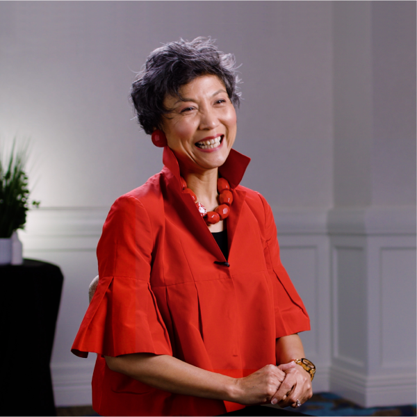 Lan J. Shaw wearing a red dress and answering questions during an interview with Commonwealth. 