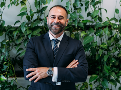 Business man smiling at camera with arms folded confidently