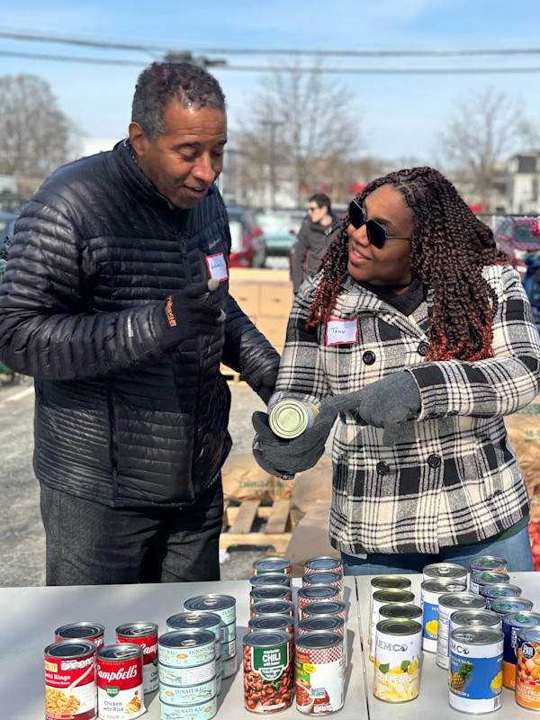 Two Commonwealth employees at a Giving Back gathering.