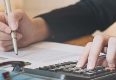 a businesswoman reviewing financial information on a spreadsheet