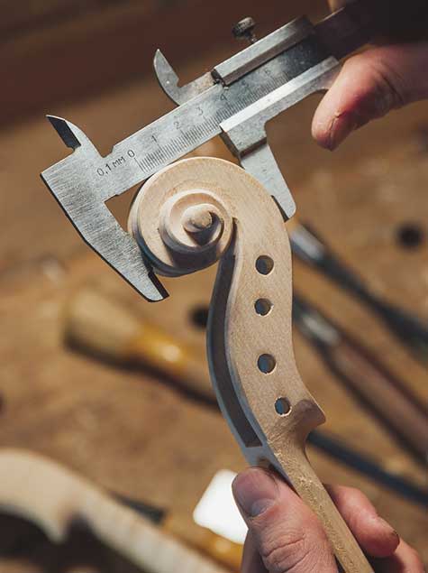 Image of violin being hand crafted; Keywords: growth, experience, consultative, team, scale and capacity, training, prospecting, strategy, digital marketing, brand design