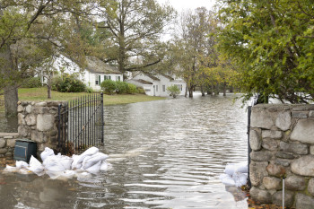 A flooded house in an oceanside community in New England shows the strength of Hurricane Sandy, a powerful storm which crashed into the Eastern USA. The gate was barricaded with sandbags, but the force of the water was too strong.