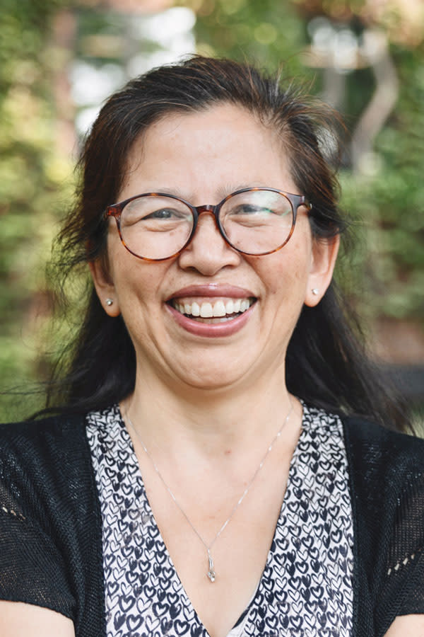 Woman looking directly into camera and smiling.