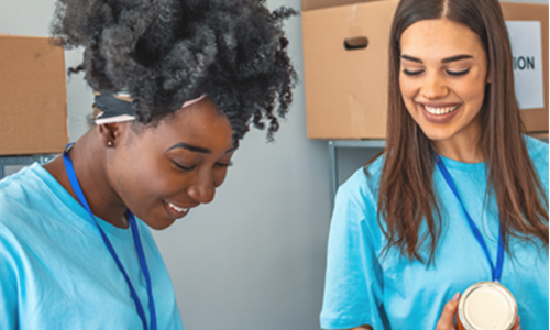 two young women volunteer on Giving Tuesday