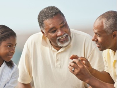a Black family spanning three generations engaged in conversation
