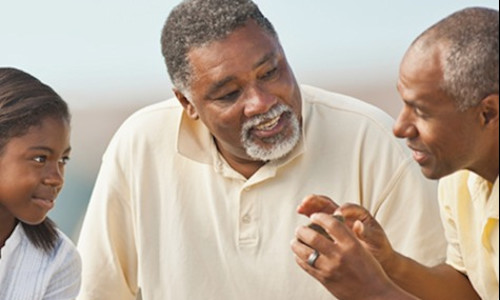 a Black family spanning three generations engaged in conversation