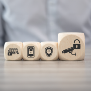 Four cubes on a table depict information security icons