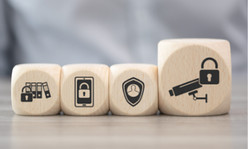 Four cubes on a table depict information security icons