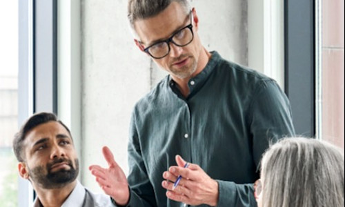 Three advisors meet to discuss hiring an associate advisor and creating an equity ownership structure.