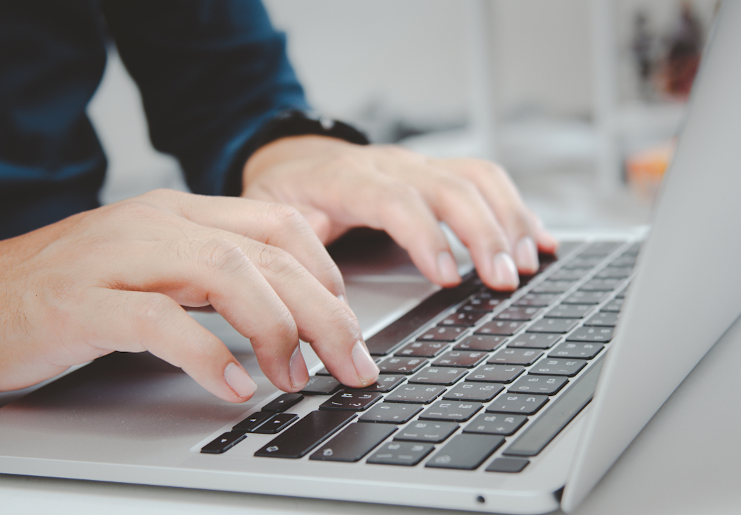 Typing on a laptop